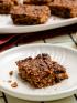 A plate with a slice of California date breakfast bar with more bars in the background for healthy sweet snack