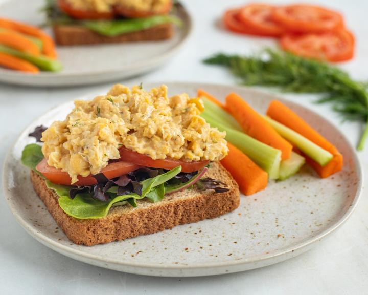 An open face vegan vegetarian sandwhich with chickpea and carrots and celery on a plate for diabetes friendly diet