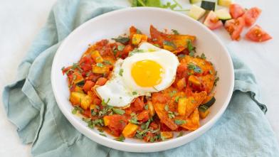 Chilaquiles with Sunny-Side-Up Eggs in a bowl with napkin for a diabetes friendly recipe