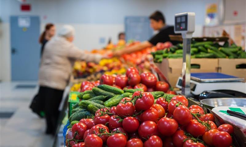 Crates at a market filled with veggies
