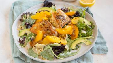 A plate with chicken, peaches, and homemade diabetes friendly dressing for a low carb style meal