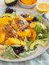 A plate with chicken, peaches, and homemade diabetes friendly dressing for a low carb style meal