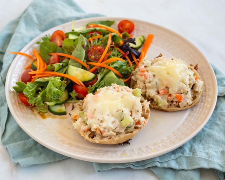 Tuna salad melt served with a salad on a plate