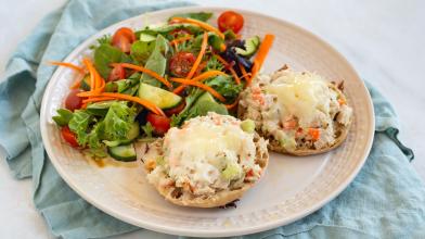 Tuna salad melt served with a salad on a plate