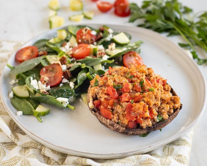 A plate with a very low carb keto meal of turkey stuffed mushroom and salad for diabetes friendly eating