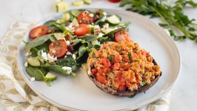 A plate with a very low carb keto meal of turkey stuffed mushroom and salad for diabetes friendly eating