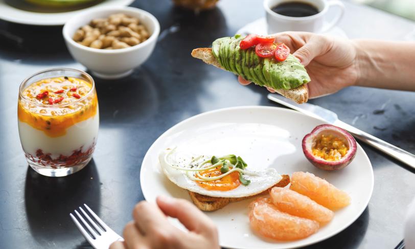 Healthy breakfast with avocado toast and fruit
