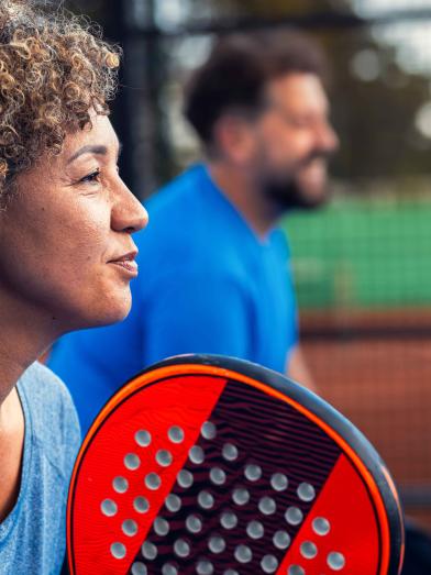 Man and woman playing pickleball