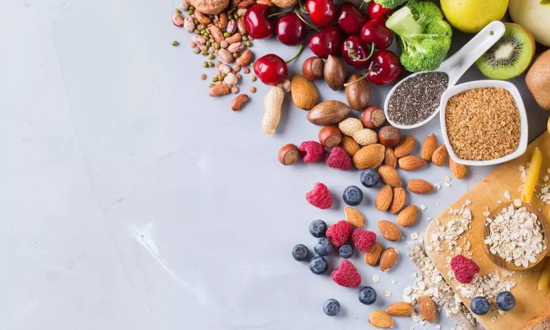 Scattered foods high in fiber like nuts, beans, and berries