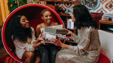 A group of women exchanging diabetes-friendly holiday gifts for food lovers